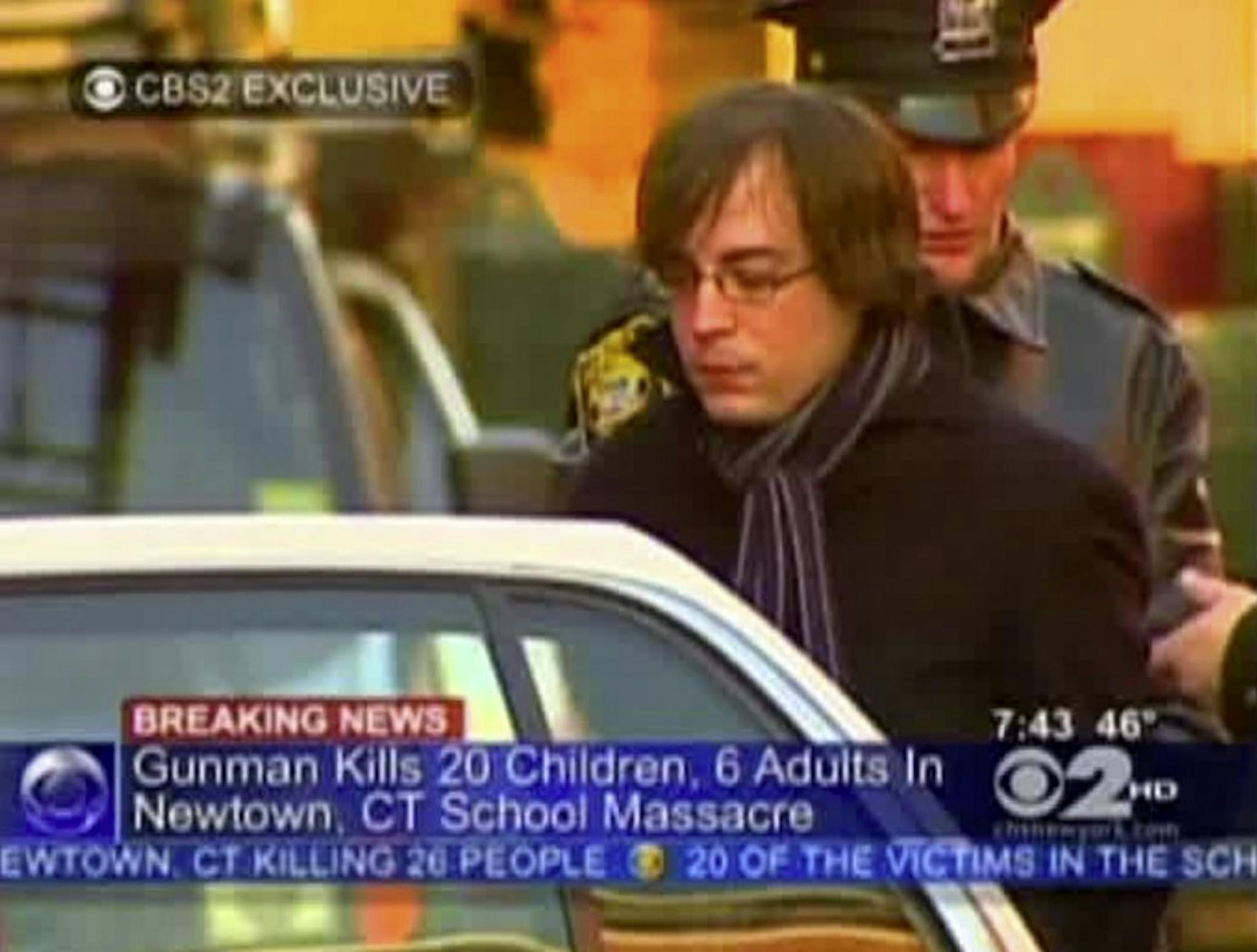 In this frame grab provided by WCBS in New York, Ryan Lanza, the 24-year-old brother of Sandy Hook Elementary School shooter Adam Lanza, is escorted by police into a cruiser in Hoboken, N.J., Friday, Dec. 14, 2012. Adam Lanza, 20, killed his mother at home and then opened fire Friday inside the elementary school where she taught, massacring 26 people, including 20 children, as youngsters cowered in fear to the sound of gunshots echoing through the building and screams coming over the intercom. (