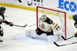 Minnesota Wild left wing Marcus Johansson, left, scores a goal against Boston Bruins goaltender Linus Ullmark (35) during the first period of an NHL h