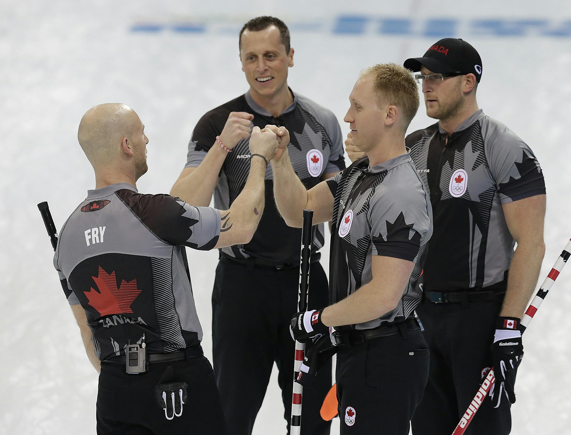 Canada's men's curling team as seen from left to right, Ryan Fry, E.J. Harnden, Brad jacobs and Ryan Harnden celebrate after beating China in the men's curling semifinal game at the 2014 Winter Olympics, Wednesday, Feb. 19, 2014, in Sochi, Russia. (AP Photo/Wong Maye-E)