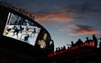 In this May 2, 2018, photo, people watch a second-round playoff series hockey game at a Vegas Golden Knights watch party outside T-Mobile Arena in Las