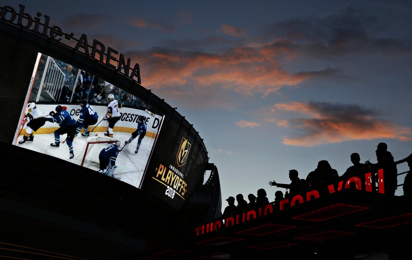 In this May 2, 2018, photo, people watch a second-round playoff series hockey game at a Vegas Golden Knights watch party outside T-Mobile Arena in Las Vegas. The expansion Golden Knights, Las Vegas' first major sports franchise, have taken the league and their hometown by storm in their first season. (AP Photo/John Locher)