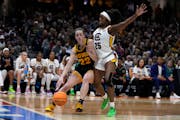 Iowa guard Caitlin Clark (22) drives past South Carolina guard Raven Johnson (25) during the first half of the Final Four college basketball champions
