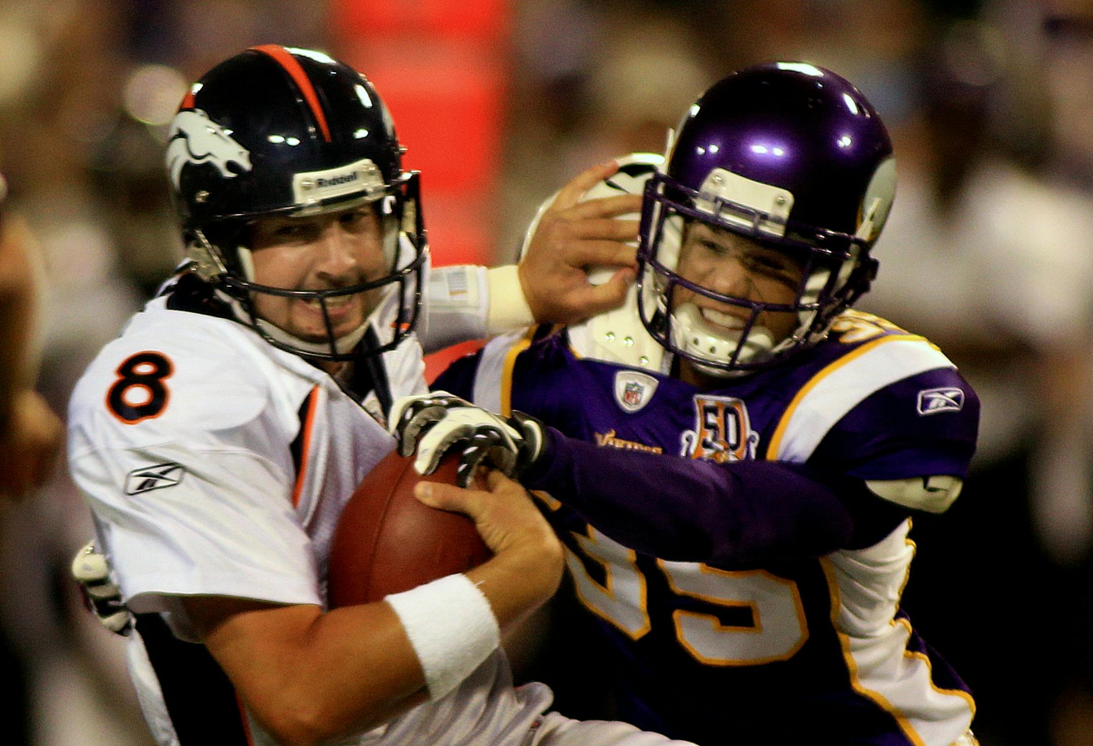 Minnesota's Marcus Sherels (right) sacked Denver quarterback Kyle Orton in the first quarter.