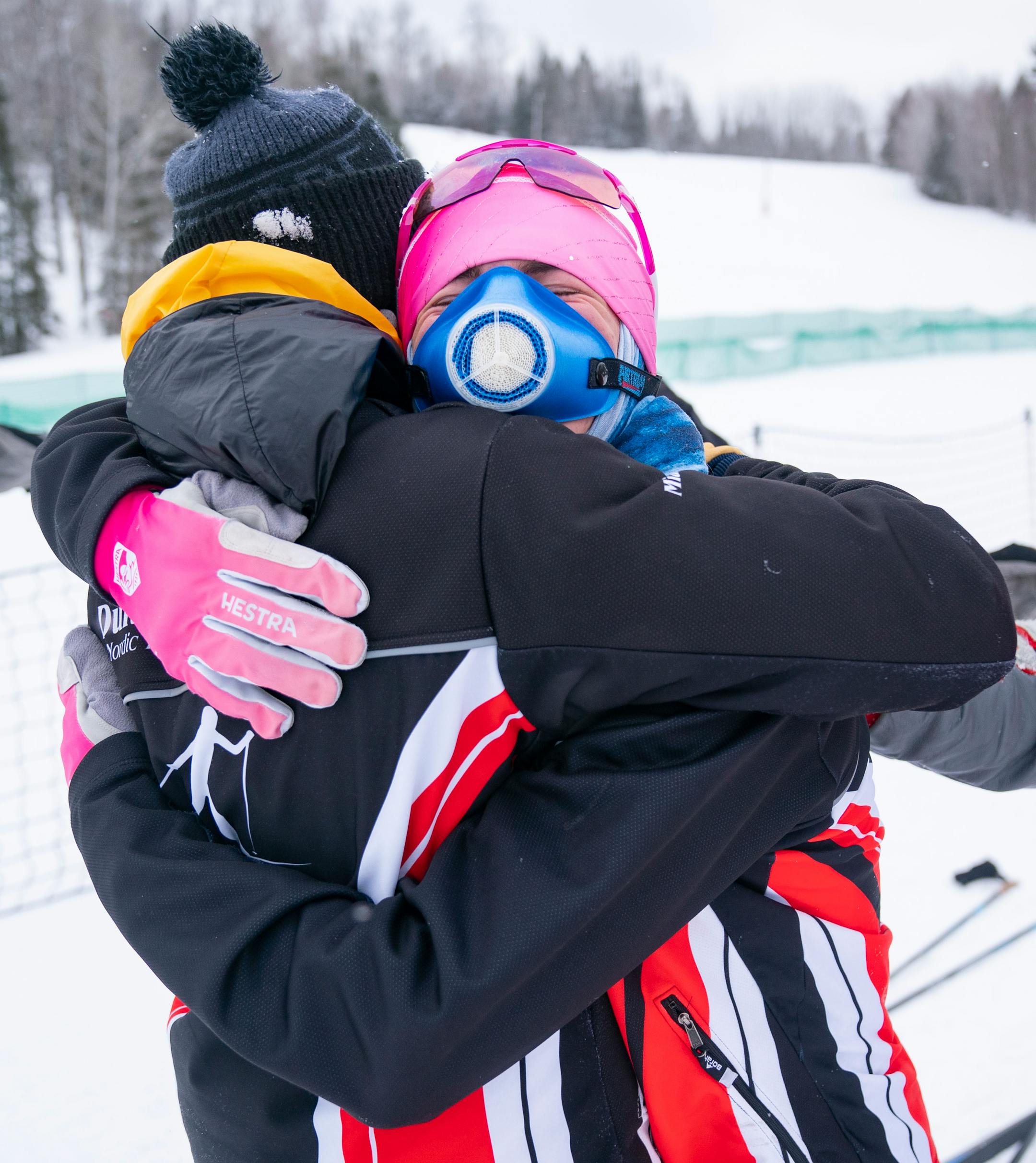 Duluth East nordic skier Oliver Miatke hugs his teammate, James Kyes, after Kyes took first place in the boy's team sprint final during the MSHSL Boys and Girls Nordic Ski Racing Meet.