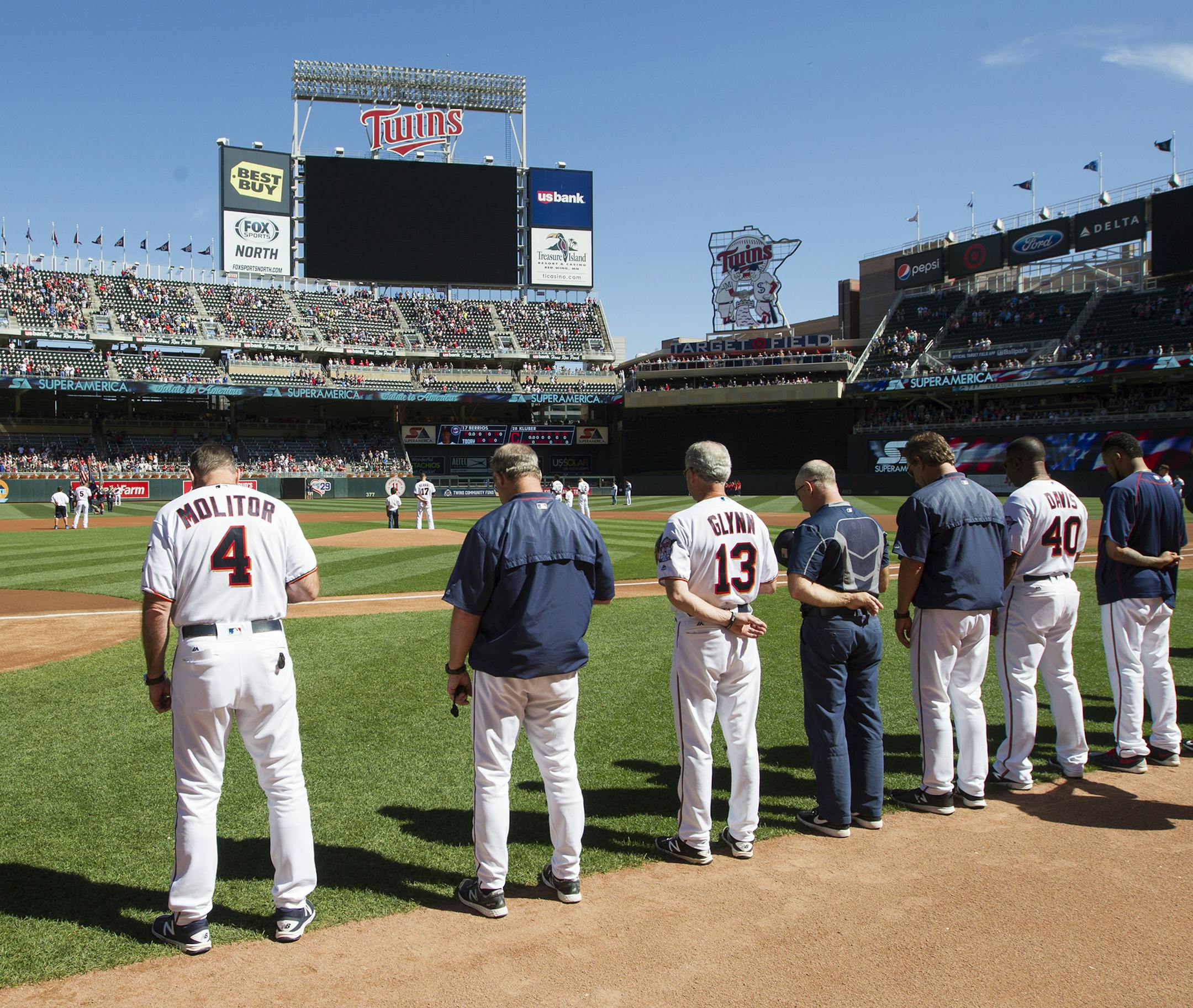 The Minnesota Twins, including manager Paul Molitor (4), stand for a moment of silence in honor of September 11th before a baseball game against the Cleveland Indians, Sunday, Sept. 11, 2016, in Minneapolis. (AP Photo/Paul Battaglia)