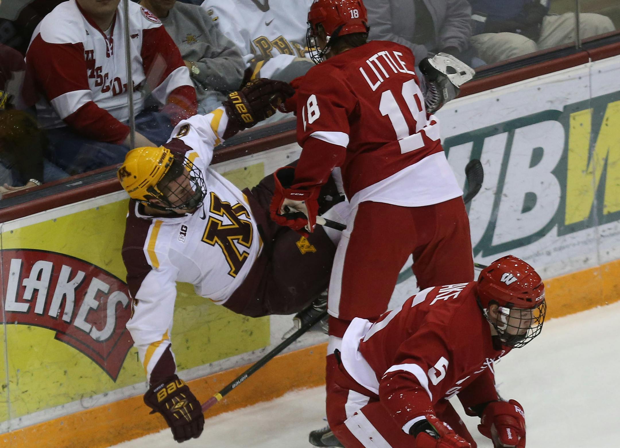Wisconsin's Sean Little knocked Gophers Jake Parenteau during the first period at Mariucci Arena in Minneapolis, Min., Saturday, November 30, 2013. ] (KYNDELL HARKNESS/STAR TRIBUNE) kyndell.harkness@startribune.com