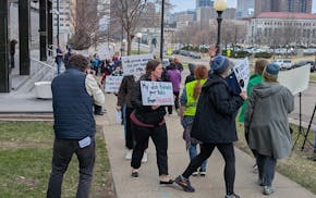 Workers protest on April 10 against layoffs by the Minnesota Department of Health that could weaken the state's response to outbreaks of infectious an