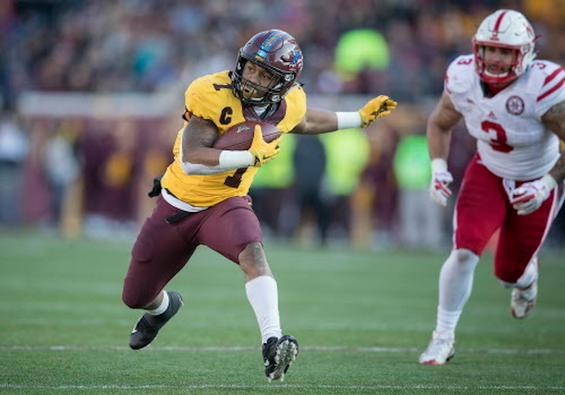 Minnesota's running back Rodney Smith rushed with the ball chased by Nebraska's linebacker Marcus Newby during the third quarter as the Gophers took on Nebraska, Saturday, November 11, 2017 at TCF Bank Stadium in Minneapolis, MN.   ]  ELIZABETH FLORES ' liz.flores@startribune.com