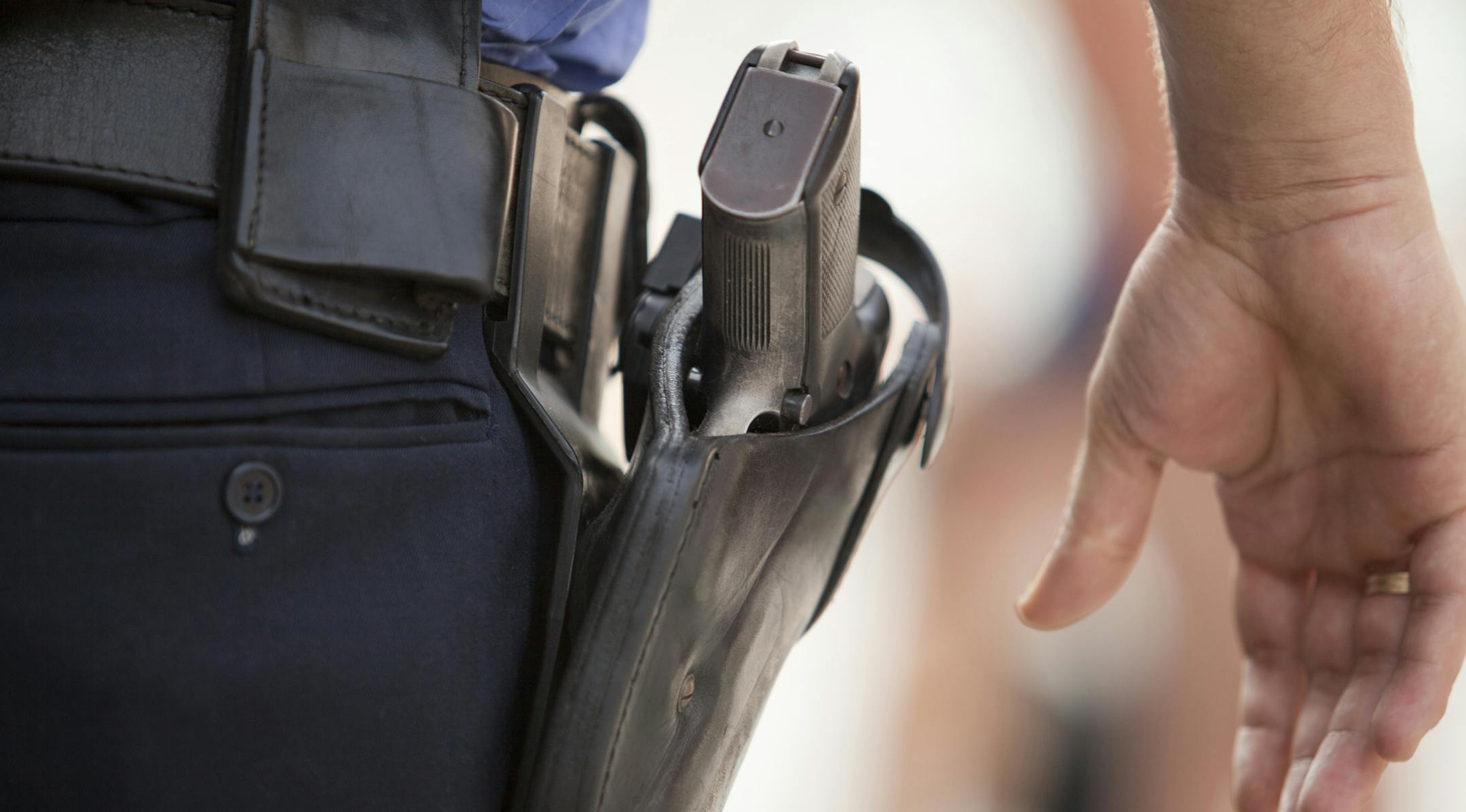 A policeman with his hand close to his gun. ORG XMIT: MIN1608021748300798