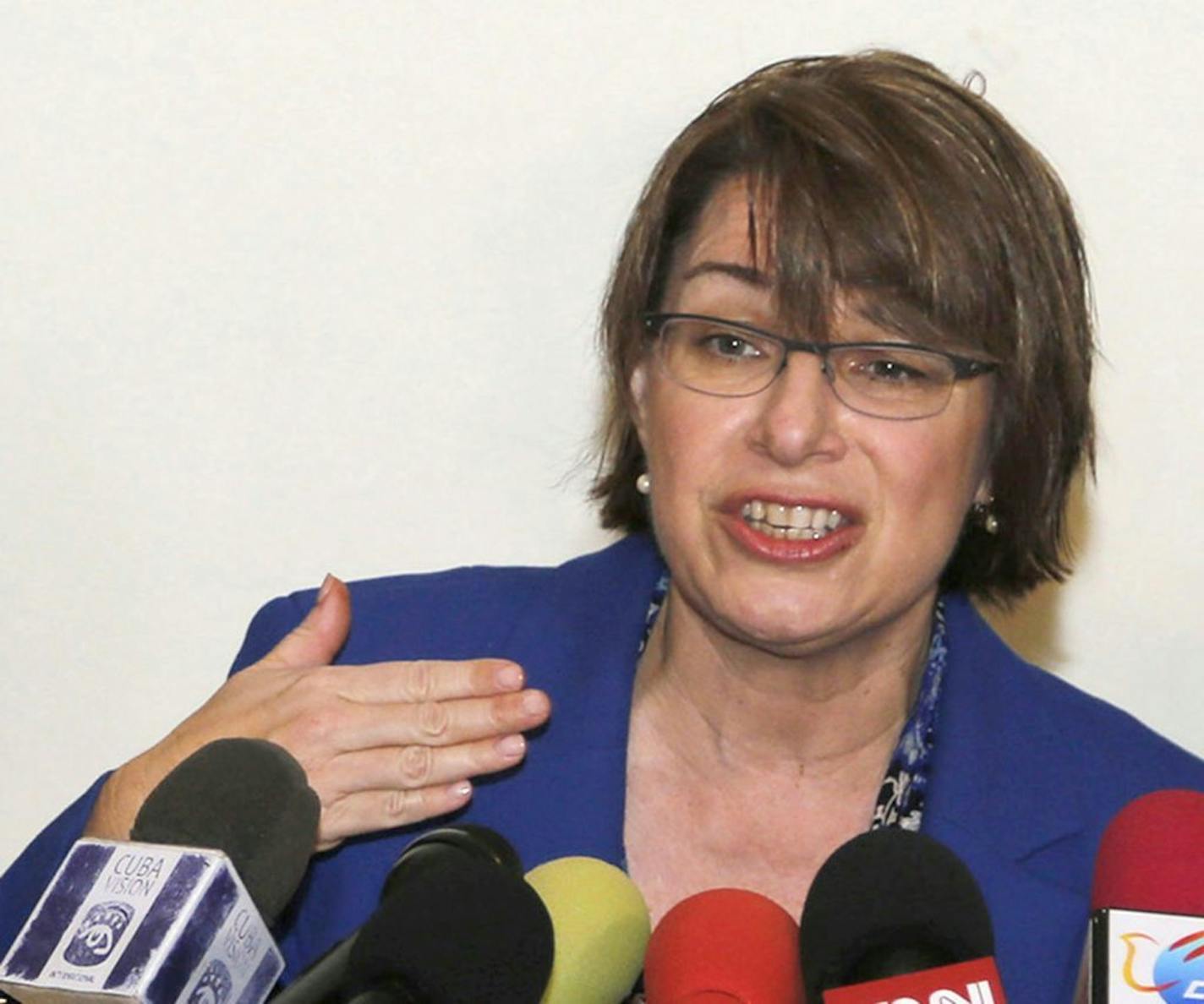 Senator Amy Klobuchar of Minnesota speaks during a press conference with fellow senators Claire McCaskill of Missouri, left, and Mark Warner of Virginia in Havana, Cuba, Tuesday, Feb. 17, 2015. The delegation is in Cuba in support of a bill Klobuchar is sponsoring to lift the U.S. trade embargo on Cuba. According to the senators, a new round of negotiations to restore full diplomatic ties with Cuba will take place next week in Washington. (AP Photo/Desmond Boylan) ORG XMIT: MIN2015021721254877 O