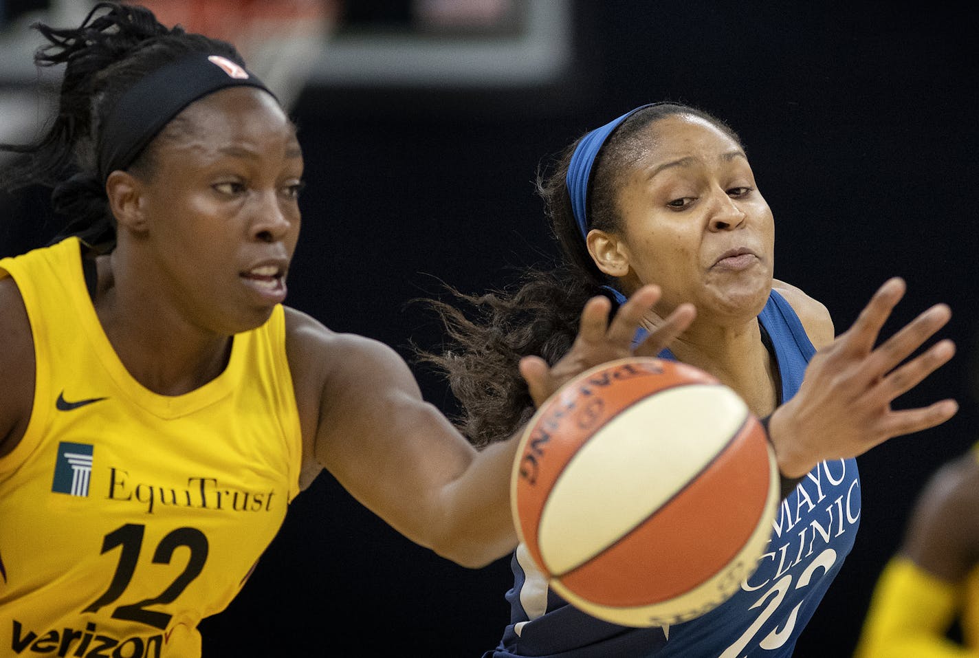 Los Angeles' Chelsea Gray and Lynx star Maya Moore fought for a loose ball in the first quarter of Sunday's season opener at Target Center. Gray's basket as time expired was the difference as the Sparks avenged last year's WNBA Finals loss by beating the Lynx 77-76.