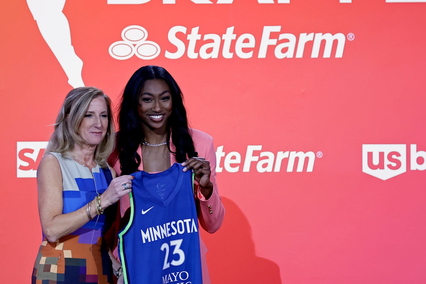 Maryland's Diamond Miller, right, poses for a photo with commissioner Cathy Engelbert after being selected by the Minnesota Lynx at the WNBA basketball draft Monday, April 10, 2023, in New York. (AP Photo/Adam Hunger)