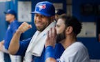 Toronto Blue Jays newly acquired starting pitcher David Price smiles in the dugout with teammate Jose Bautista over the weekend.
