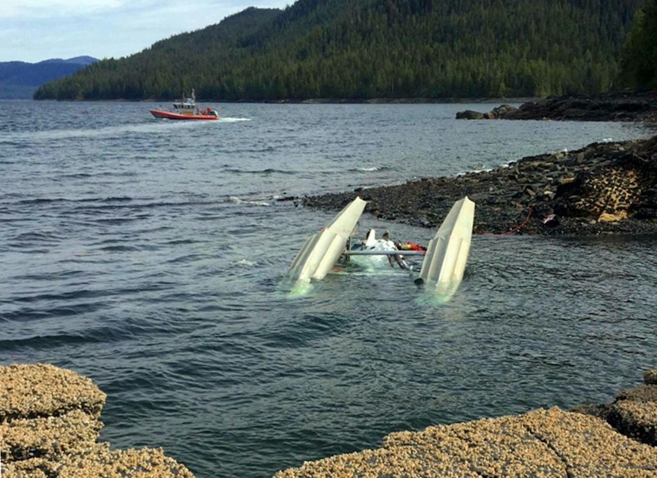 This May 13, 2019 photo provided by Ryan Sinkey, shows a Coast Guard Station Ketchikan response boat crew searching for survivors from a downed floatplane in the vicinity of George Inlet near Ketchikan, Alaska. Two floatplanes carrying cruise ship tourists collided Monday near the southeast Alaska town of Ketchikan.