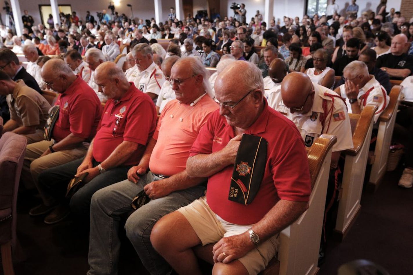 Supporters bow their heads in prayer for the start of an interfaith vigil at Olivet Baptist Church held in remembrance of victims of the July 16 shootings on Friday, July 17, 2015, in Chattanooga, Tenn. The vigil was held one day after gunman Mohammad Youssef Abdulazeez shot and killed four U.S. Marines and wounded two others and a Chattanooga police officer at the Naval Operational Support Center on Amnicola Highway shortly after firing into the Armed Forces Career Center on Lee Highway.