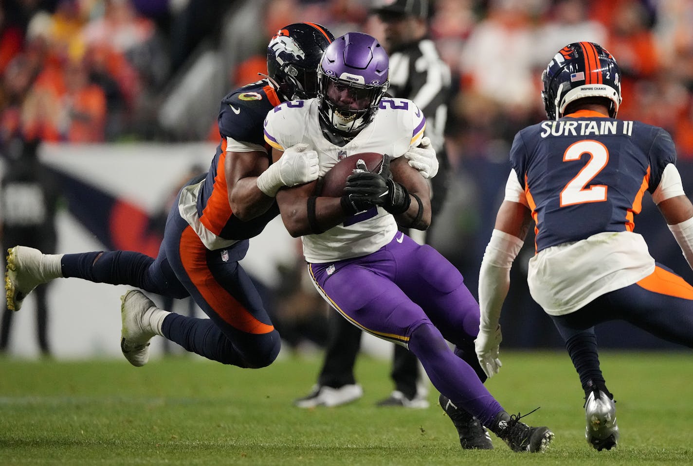 Minnesota Vikings running back Alexander Mattison (2) is brought down by Denver Broncos linebacker Jonathon Cooper (0) in the fourth quarter of an NFL game between the Minnesota Vikings and the Denver Broncos Sunday, Nov. 19, 2023 at Empower Field at Mile High in Denver.. ] ANTHONY SOUFFLE • anthony.souffle@startribune.com