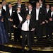 Peter Farrelly, center, and the cast and crew of "Green Book" accept the award for best picture at the Oscars on Sunday, Feb. 24, 2019, at the Dolby T