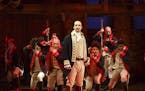 This image released by The Public Theater shows Lin-Manuel Miranda, foreground, with the cast during a performance of "Hamilton," in New York.