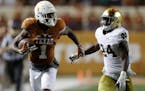 Texas wide receiver John Burt ran from Notre Dame defensive back Nick Coleman during a 72-yard touchdown reception in the second half Sunday in Austin