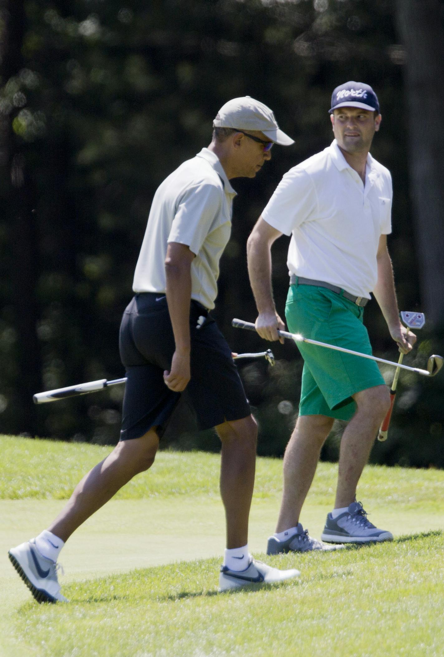 President Barack Obama, center, Cy Walker, left, and Joe Paulsen, right, leave the first green during a round of golf at Farm Neck Golf Course in Oak Bluffs, Mass., on Martha's Vineyard, Sunday, Aug. 7, 2016. (AP Photo/Manuel Balce Ceneta) ORG XMIT: OTKMC121