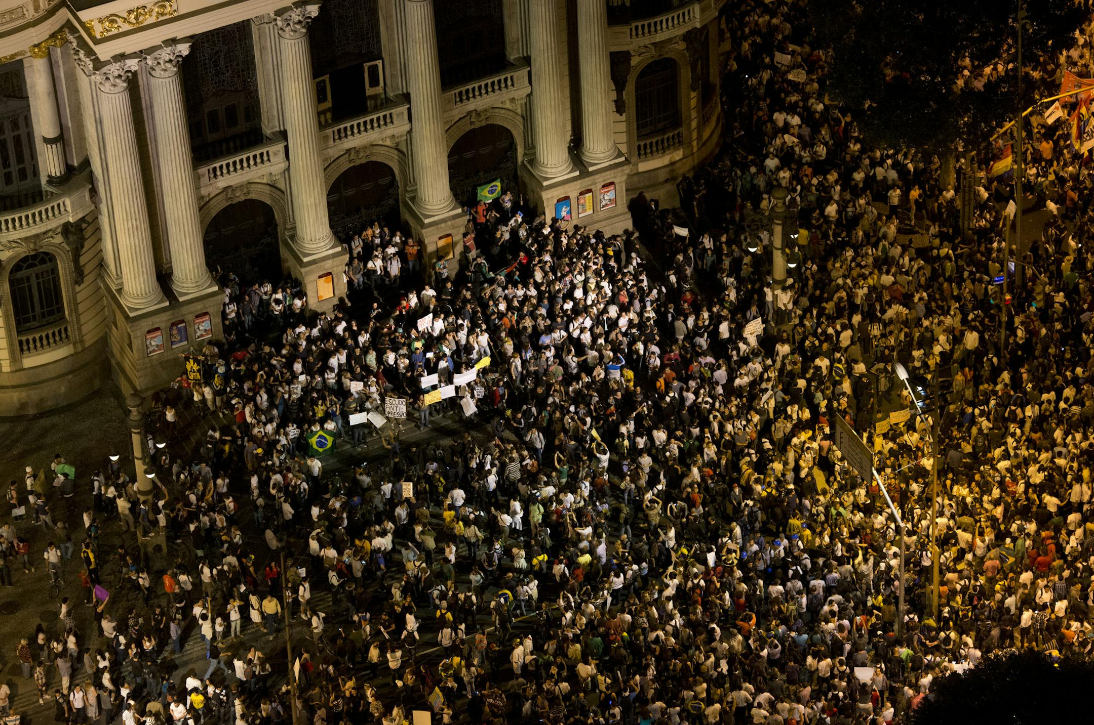 Protestors gather at the Municipal theater during a march in Rio de Janeiro, Brazil, Monday, June 17, 2013. Protesters massed in at least seven Brazilian cities Monday for another round of demonstrations voicing disgruntlement about life in the country, raising questions about security during big events like the current Confederations Cup and a papal visit next month. (AP Photo/Felipe Dana) ORG XMIT: MIN2013062415424461