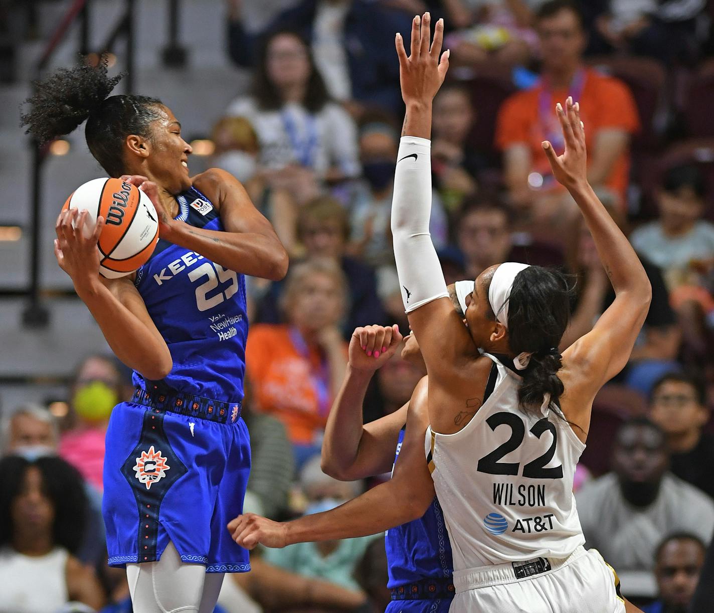 Connecticut Sun forward Alyssa Thomas (25) gets the offensive rebound over teammate Brionna Jones (42) and Las Vegas Aces forward A'ja Wilson (22) during a WNBA basketball game, Sunday, July 17, 2022, in Uncasville, Conn. (Sean D. Elliot/The Day via AP)