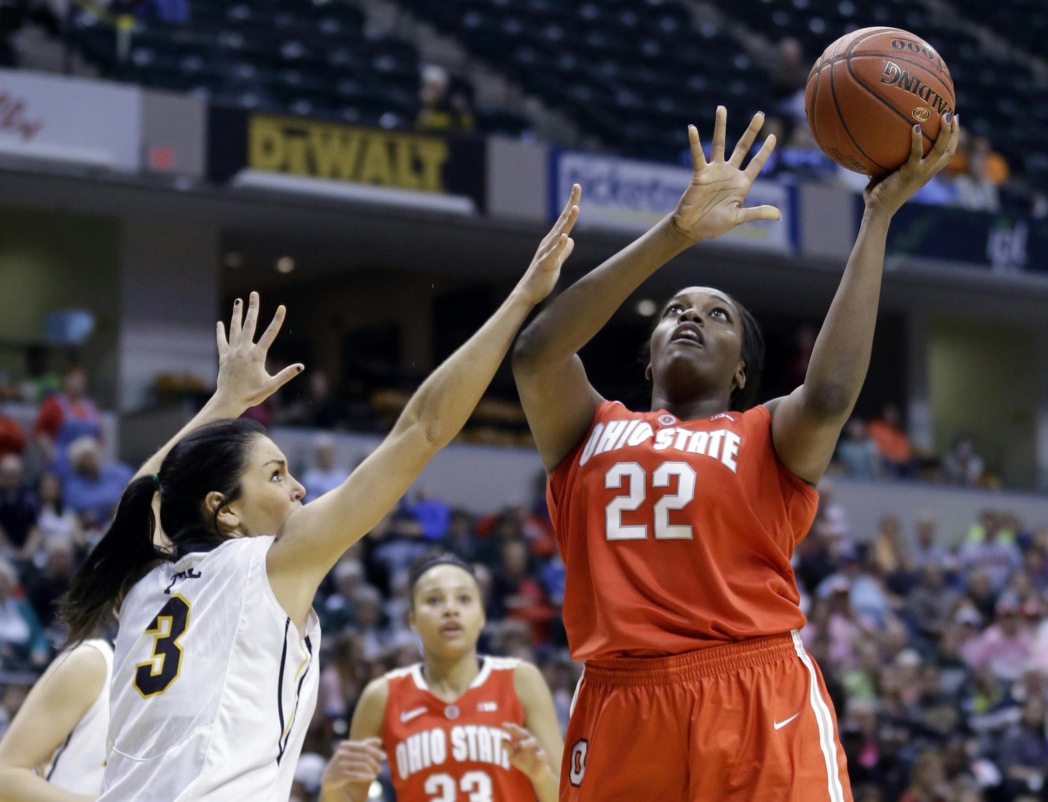 Ohio State center Darryce Moore, right, shoots over Iowa forward Claire Till in the second half of an NCAA college basketball game in the semifinals of the Big Ten women's tournament in Indianapolis, Saturday, March 8, 2014. Iowa defeated Ohio State 77-73. (AP Photo/Michael Conroy)