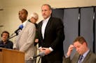 US Attorney Andy Luger, center, and Richard Thornton, the FBI's special agent in charge of the Minneapolis office, right, sat with Sadik Warfa, left, 
