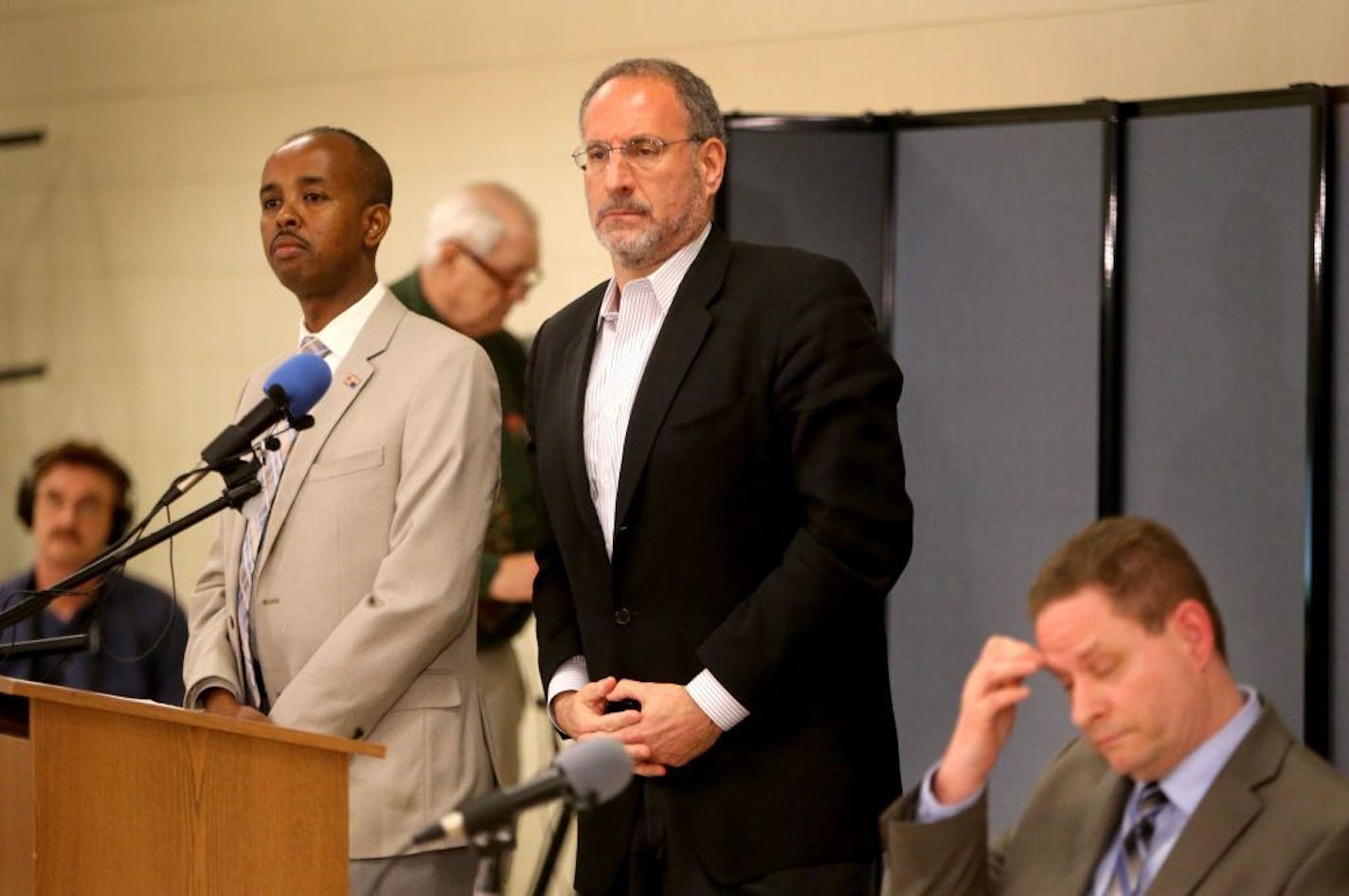 US Attorney Andy Luger, center, and Richard Thornton, the FBI's special agent in charge of the Minneapolis office, right, sat with Sadik Warfa, left, during a town hall meeting with members of the Somali community about the recent charges against six men accused of trying to join ISIL at the Phillip's Community Center Saturday, May 9, 2015, in Minneapolis, MN.