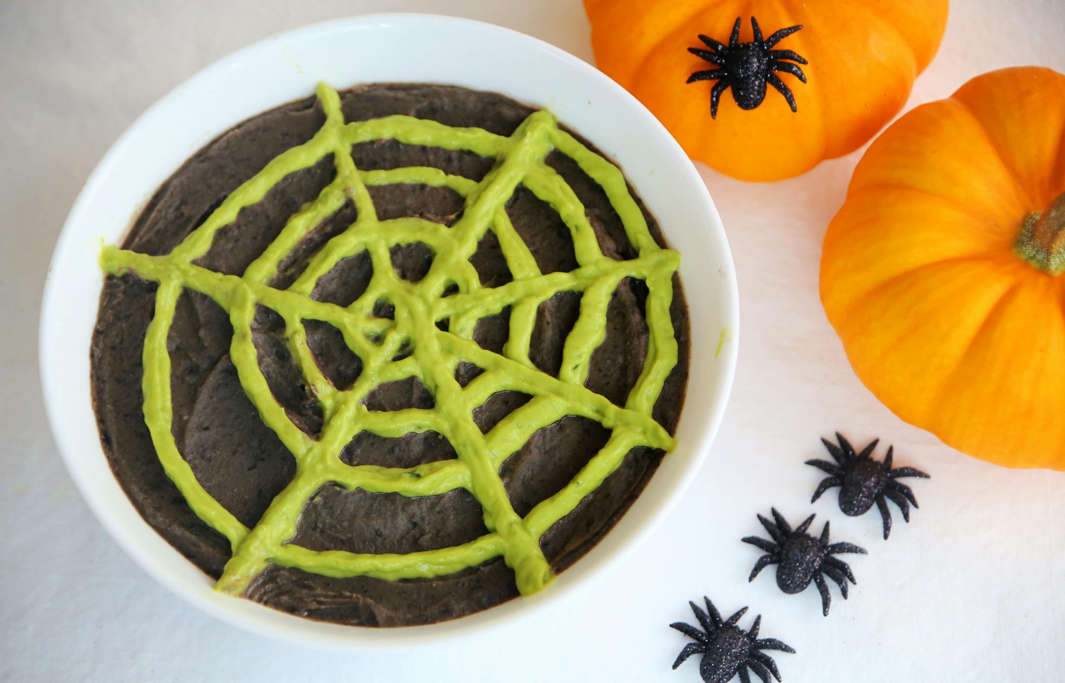 Halloween Black Bean-Olive Soup With Avocado Spiderwebs.