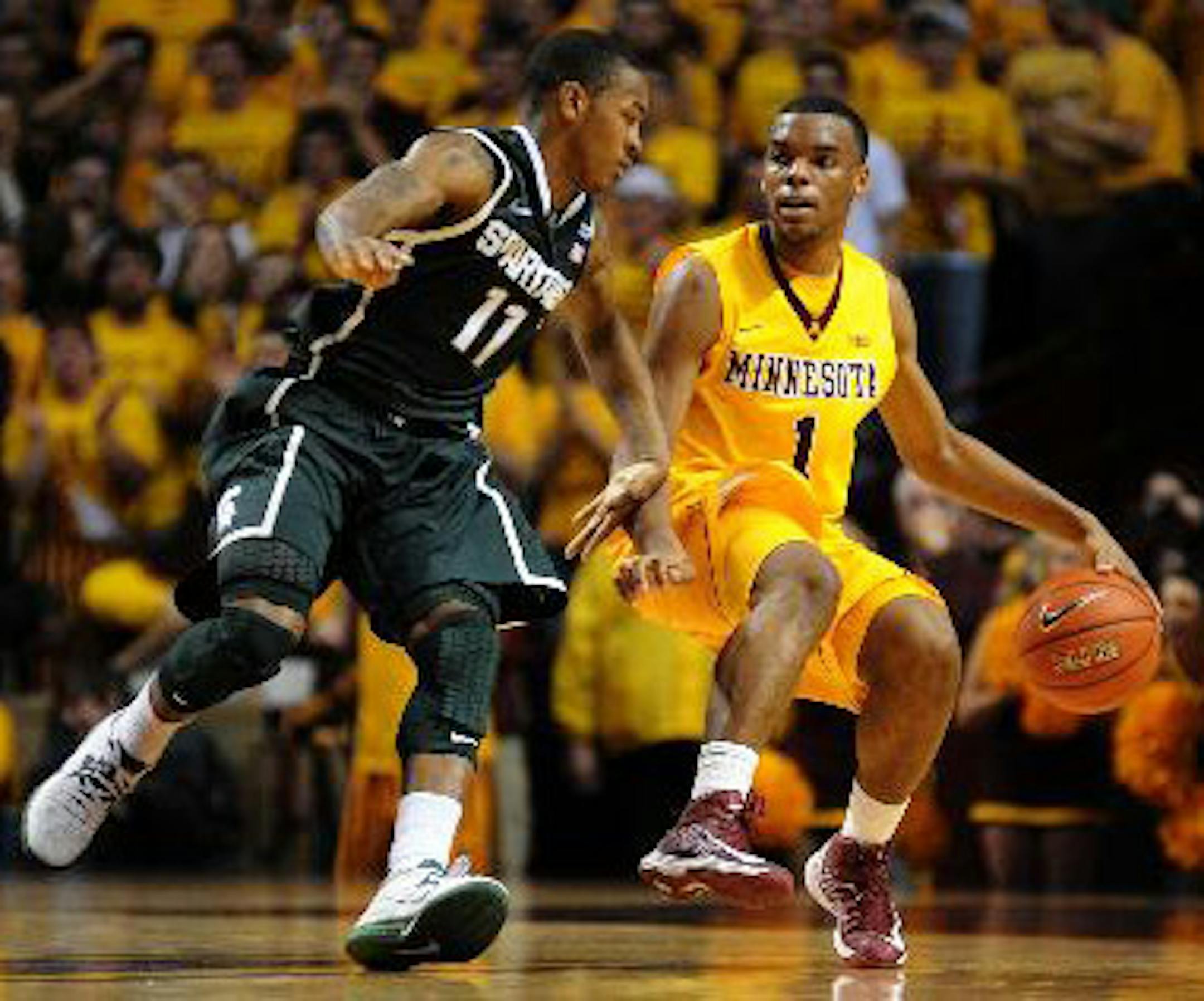 Andre Hollins brings the ball up court against Michigan State's Keith Appling. Richard Sennott / StarTribune.com