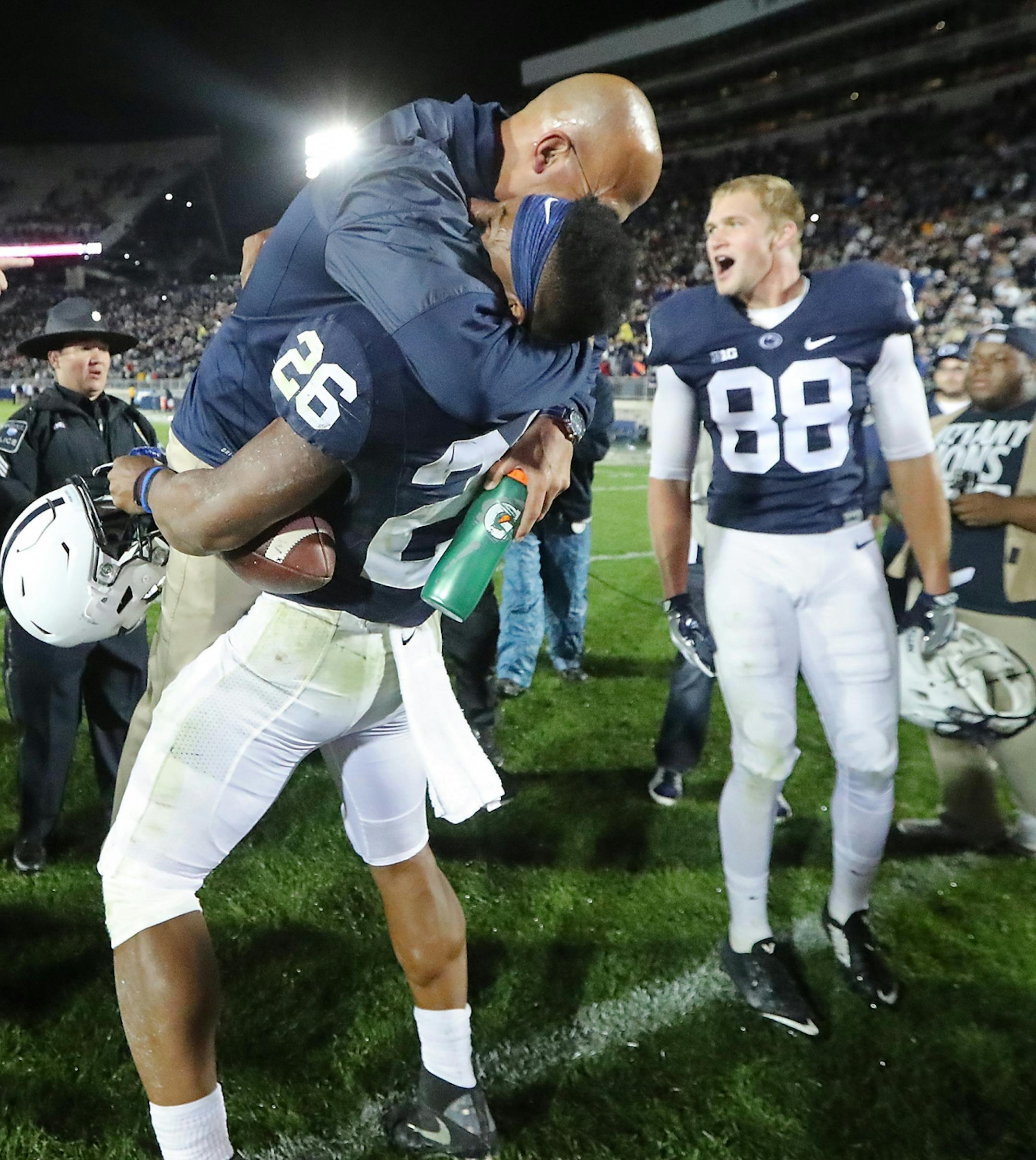 Penn State's head coach James Franklin gave running back Saquon Barkley a big hug after he scored the winning touchdown beating Minnesota 29-23 in overtime at Beaver Stadium, Saturday, October 1, 2016 in State College, PA.