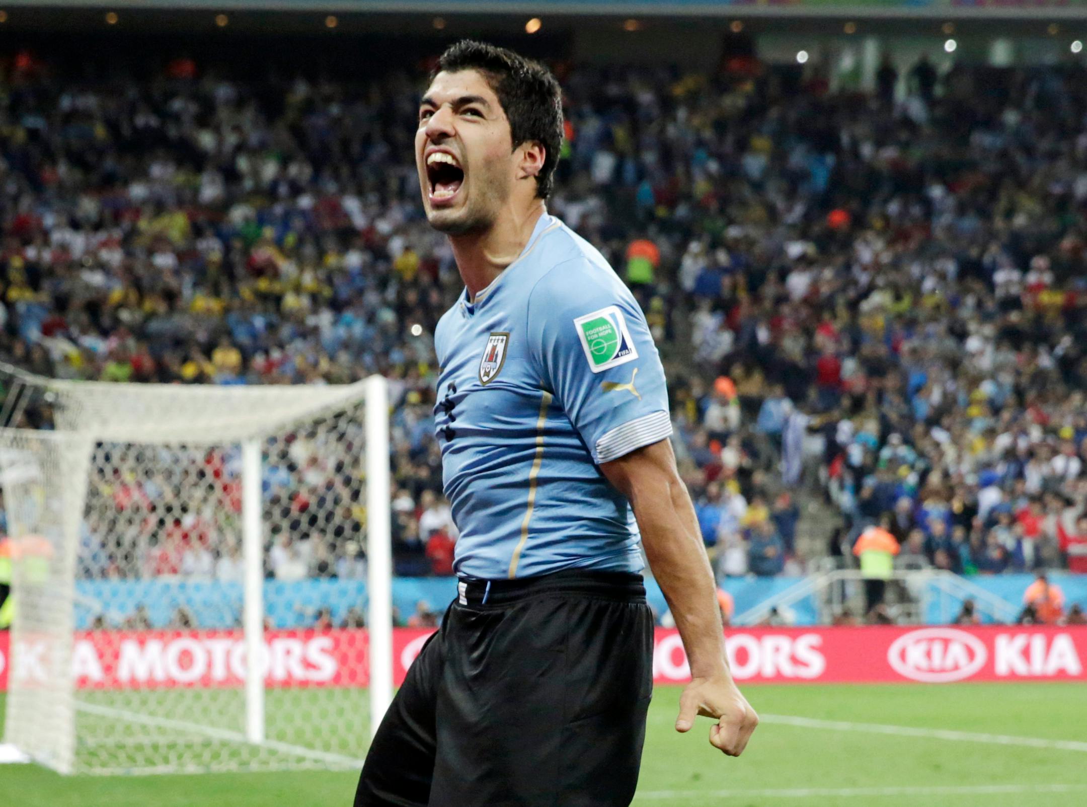 FILE - This is a Thursday, June 19, 2014 file photo of Uruguay's Luis Suarez as he celebrates after scoring his side's second goal during the group D World Cup soccer match between Uruguay and England at the Itaquerao Stadium in Sao Paulo, Brazil. The Court of Arbitration for Sport on Thursday Aug. 14, 2014 upheld Luis Suarez's four-month ban for biting an opponent at the World Cup, but cleared him to train with Barcelona. (AP Photo/Matt Dunham, File)