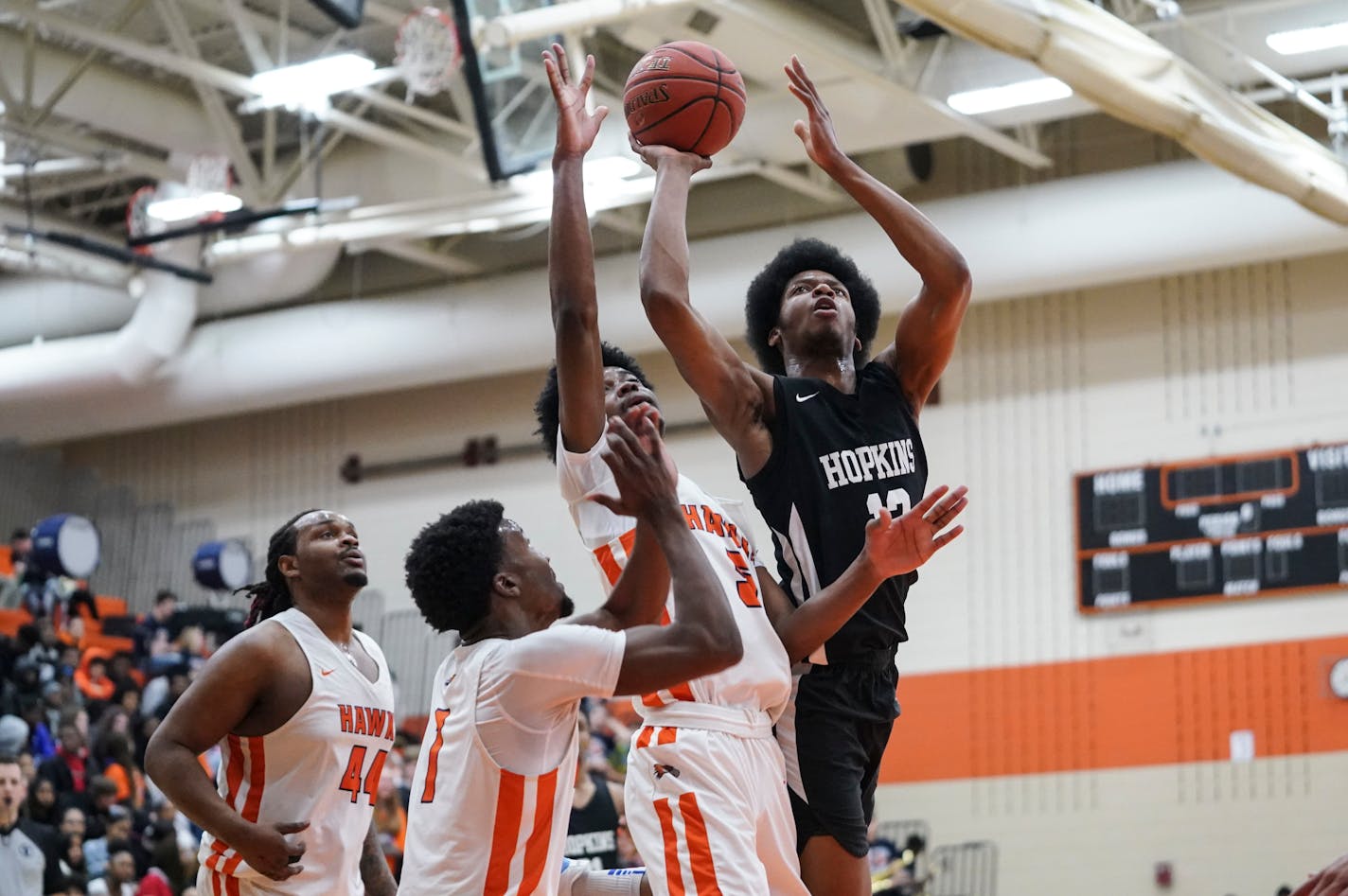 Hopkins guard Kerwin Walton (12) jumped for a two-point shot Cooper guard Broderick Powell Jr. (1) and Cooper forward Jeffrey Cooper (5) in the second half. ] RENEE JONES SCHNEIDER ¥ renee.jones@startribune.com at Hopkins High School verses Cooper High School in the boys basketball 4A, Section 6 final at Osseo High School in Osseo, Minn., on Wednesday, March 11, 2020.