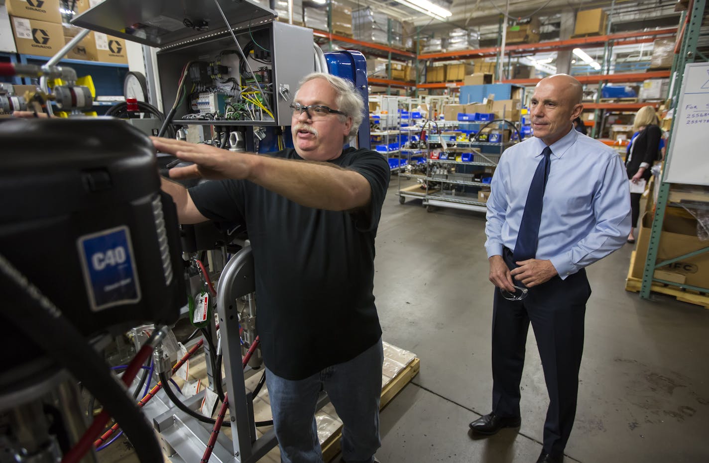 Graco CEO Pat McHale, 56, (right) started working in factories a mile from the Graco Plant when he attended Edison High. He joined Graco as a night-shift machinist supervisor in 1989. And the company has had record perfromance on his watch since 2007. Here, CEO Pat McHale (right) talks with Joe Christopherson in the plant.] Brian.Peterson@startribune.com Minneapolis, MN - 04/19/2016