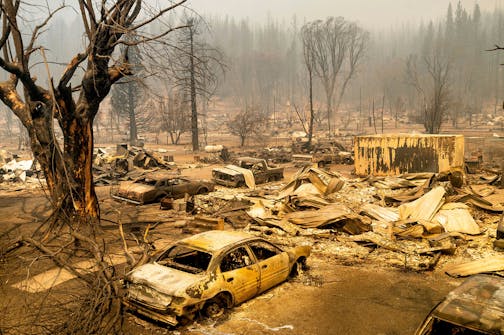 This photo shows cars and homes destroyed by the Dixie Fire line central Greenville on Thursday, Aug. 5, 2021, in Plumas County, Calif. (AP Photo/Noah Berger)