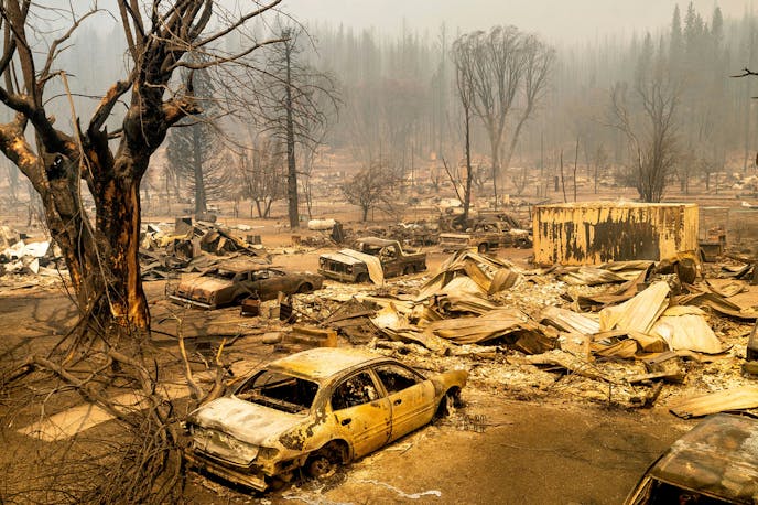 This photo shows cars and homes destroyed by the Dixie Fire line central Greenville on Thursday, Aug. 5, 2021, in Plumas County, Calif. (AP Photo/Noah Berger)