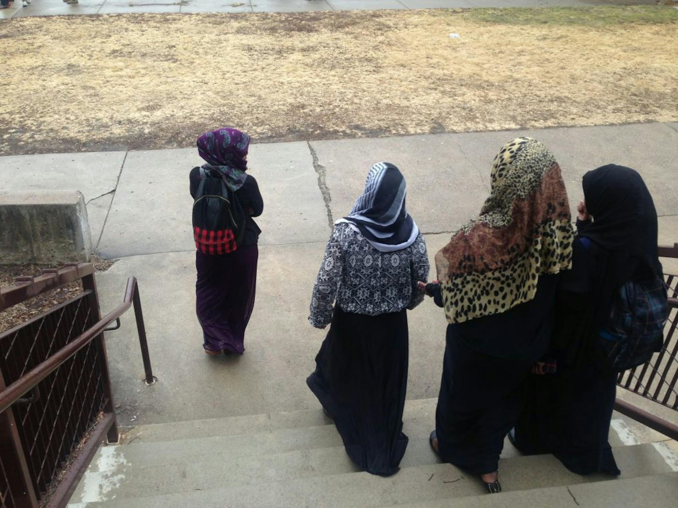 Somali students walk down the steps at Tech High School on Friday, as chaos breaks out on the lawn. The St. Cloud school district has been roiled by tensions between whites and Somali students for the last decade - so much so that it had to reach a settlement with the U.S. Dept. of Ed a few years back - and that reached a boiling point this week. More than 100 Somali students walked out to protest the administration's indifference to their complaints of bullying and harassment, particularly for