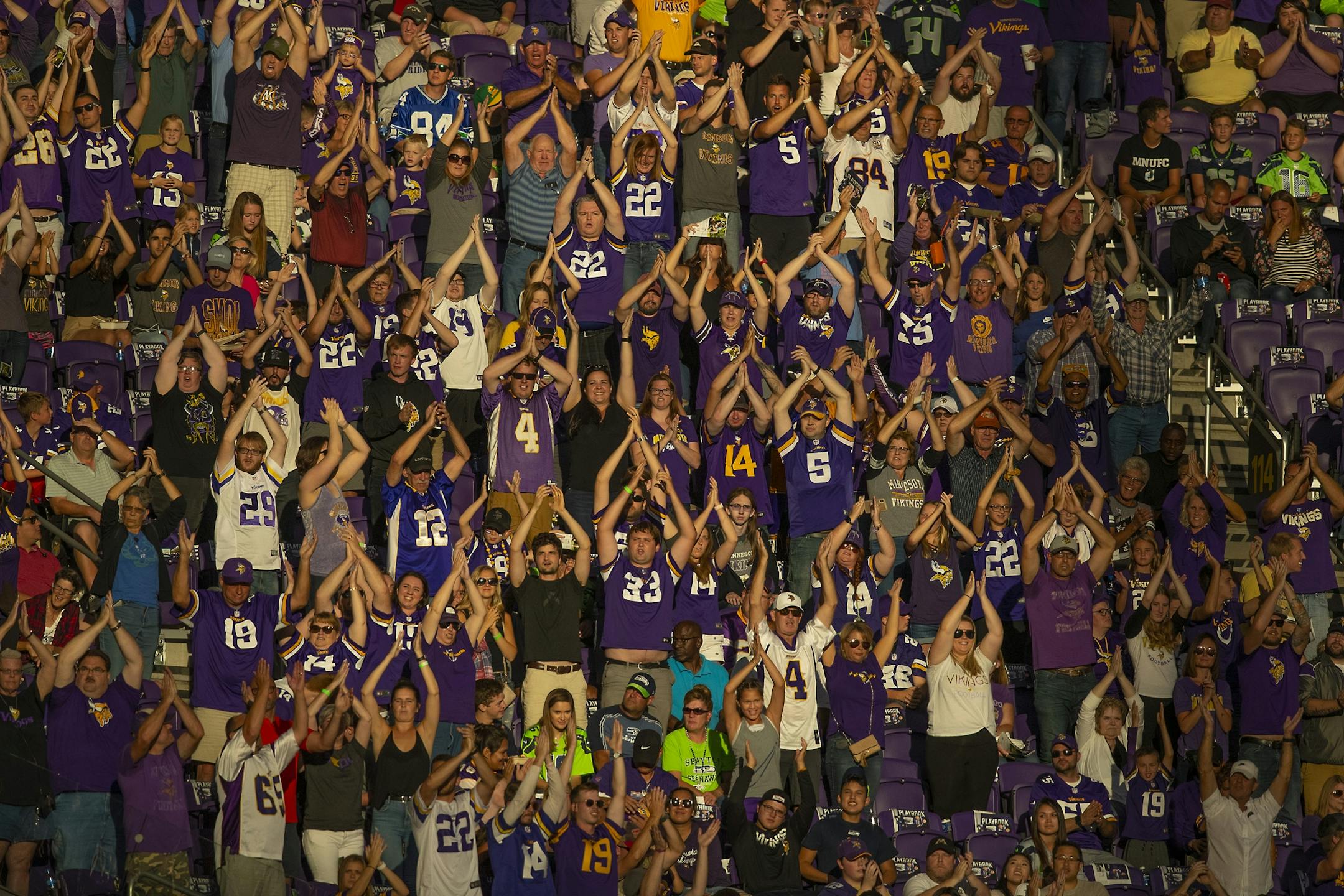 Vikings fans are lit by the sun setting as they cheered the team onto the field before the pre-season matchup between the Minnesota Vikings and the Seattle Seahawks at US Bank Stadium, Sunday, August 18, 2019 in Minneapolis, MN.