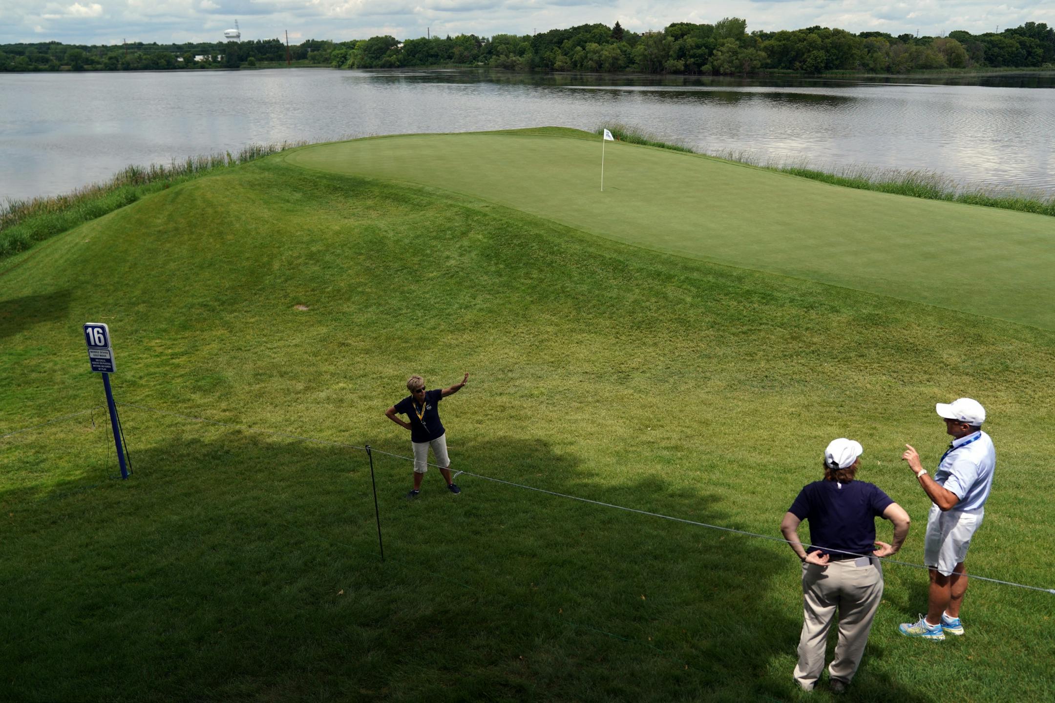 Course workers presided over the 16th green Tuesday afternoon.