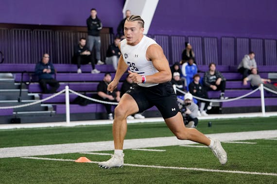 Running back Evan Hull, who played high school football at Maple Grove, ran a drill during Northwestern’s pro day last month.
