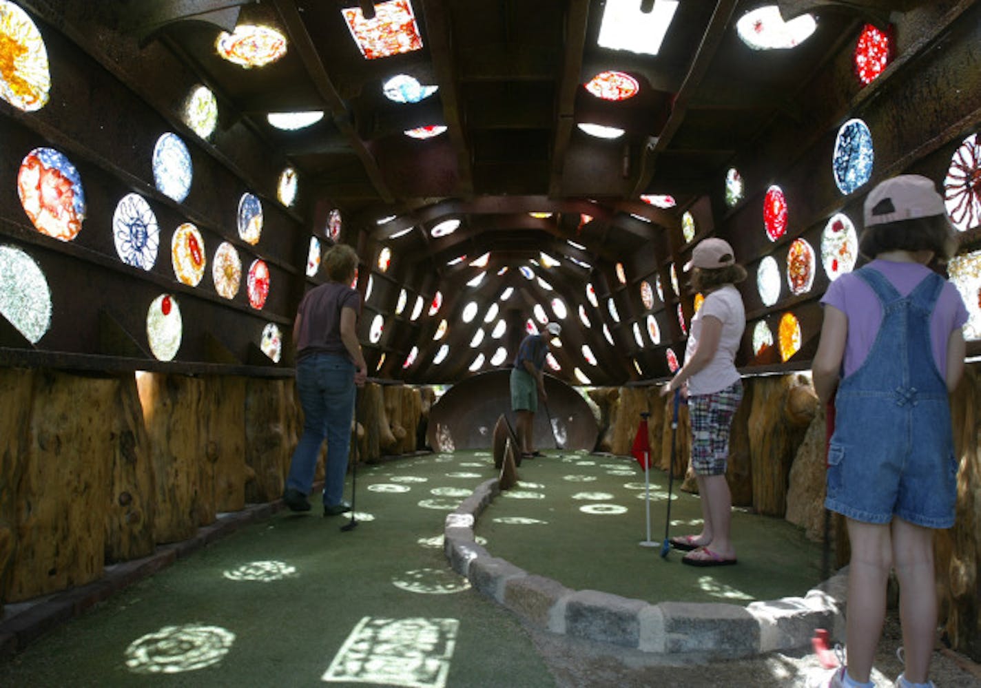 Melinda (mother), Matt, Ellie (10 pink shirt), and Lizzy Pfohl (7) ,of Mound, Mn play the 7th hole, Holey ship. Bruce Stillman owns Bigstone mini golf and Sculpture gardens is the newest miniature-golf course in Minnetrista. The Big Stone course is built around objects d�art, and really good ones at that.