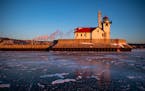 The Duluth Harbor south breakwater outer light was was illuminated by the rising sun over a frozen Lake Superior on Tuesday.