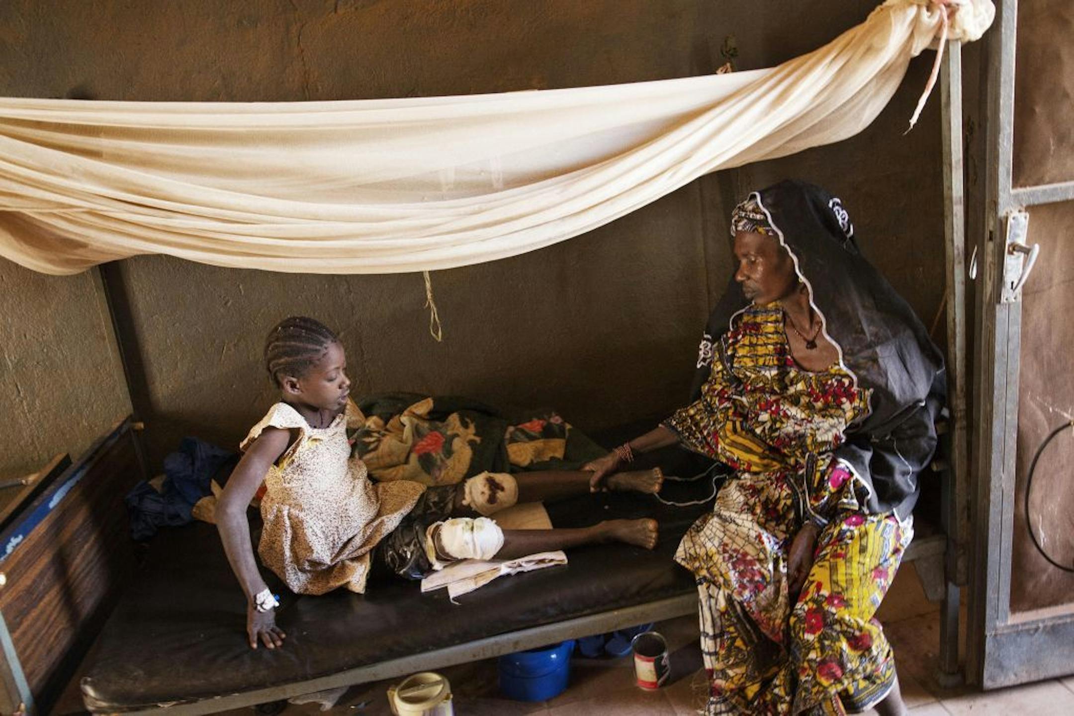 Dade Diallo with her daughter, Coumber Bah, 12, who was wounded in Diabaly by a stray bullet, in Niono, Mali, Jan. 23, 2013.