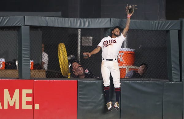 Minnesota Twins center fielder Byron Buxton (25) robbed Cleveland Indians designated hitter Edwin Encarnacion (10) of a home run in the 7th inning at 