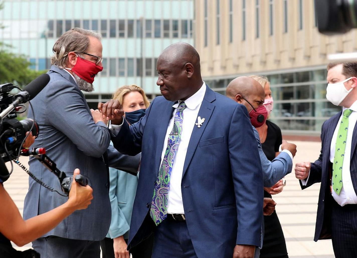 Attorney Ben Crump, who represents George Floyd's family, announced in a press conference that the family of Floyd is suing the city of Minneapolis and the four officers involved in his death, citing a failure in proper police training and a racist departmental culture that led to a "reckless disregard" of Floyd's civil rights Wednesday outside the US Federal Courthouse in Minneapolis. Here, Crump, center, is seen with his team of lawyers.