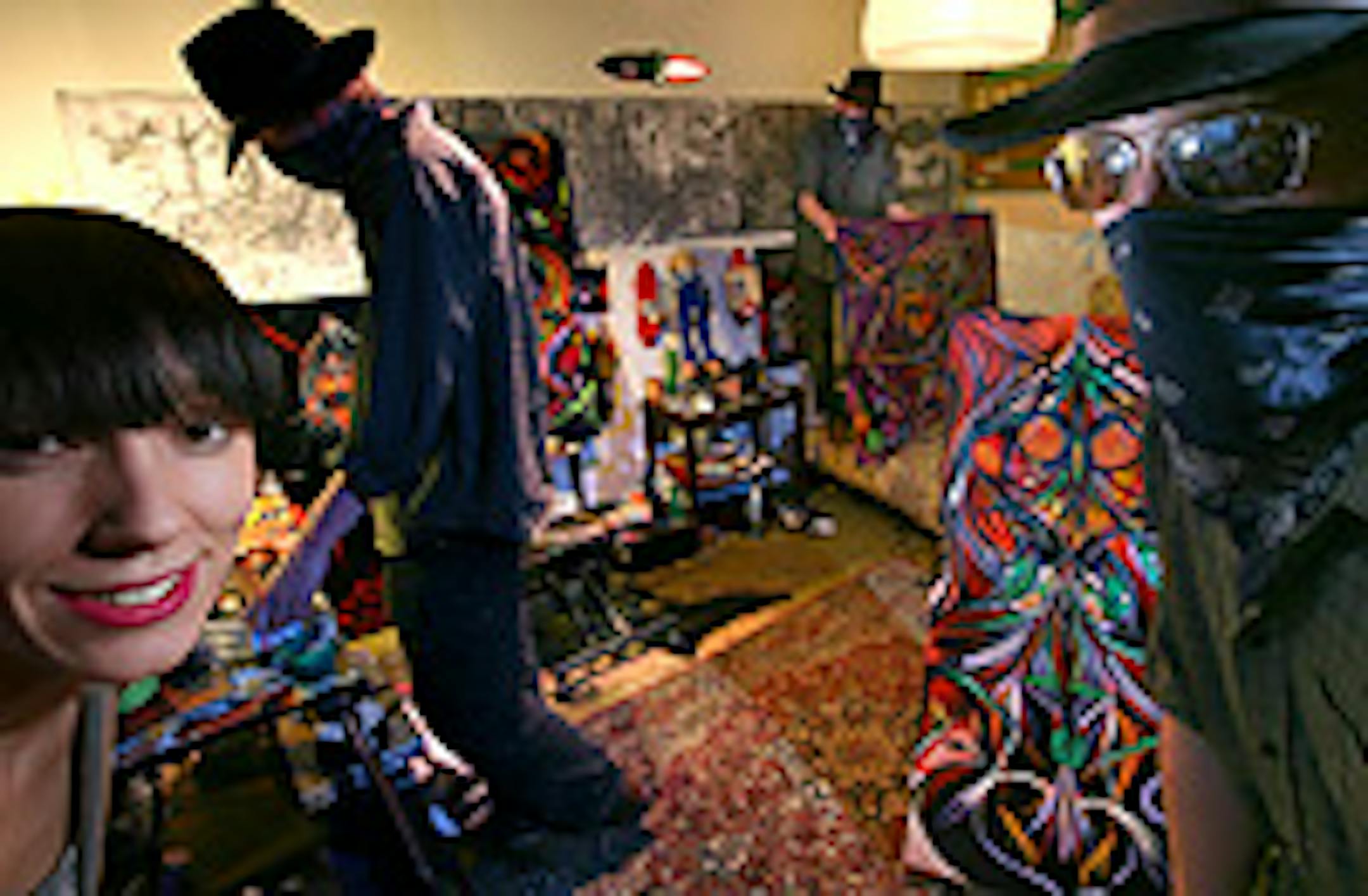 "I Dreamed I Dream" curator Emma Berg, left, and street artist Deuce Seven (shown in disguise and in triplicate) prepared for the exhibit.