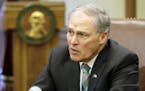 Washington Gov. Jay Inslee talks to reporters after taking part in the signing of a climate agreement with British Columbia Premier John Horgan, Frida
