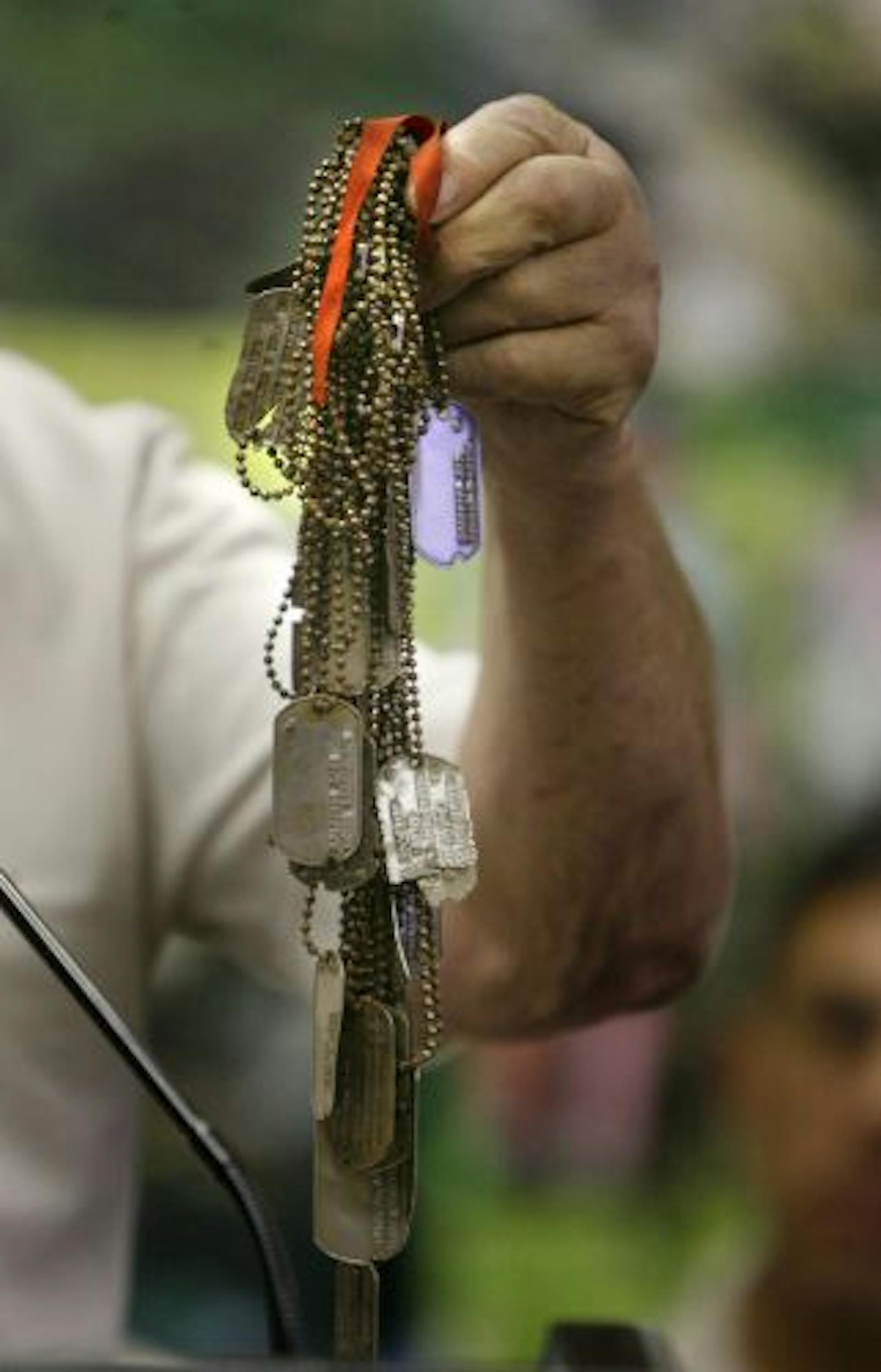 Bryan Moon, the Missions Director, held up a handful of military dog tags that the group has recovered throughout their missions.