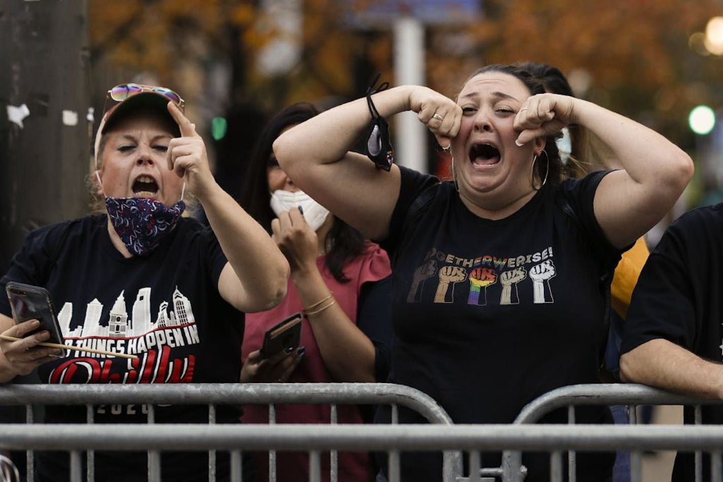 Supporters of President-elect Joe Biden taunt supporters of President Donald Trump as they protest outside the Pennsylvania Convention Center in Philadelphia, Sunday, Nov. 8, 2020, a day after the 2020 election was called for Democrat Joe Biden.